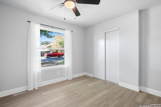 interior space featuring light wood-type flooring, a closet, and ceiling fan