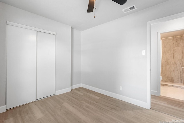 unfurnished bedroom with ceiling fan, a closet, and light hardwood / wood-style floors