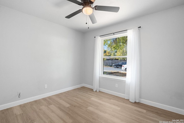 empty room featuring ceiling fan and light wood-type flooring