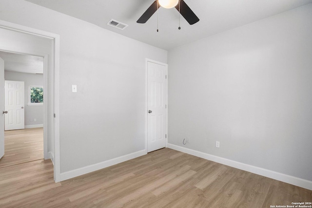 spare room featuring ceiling fan and light hardwood / wood-style floors