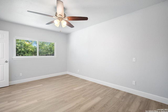 empty room with ceiling fan and light wood-type flooring