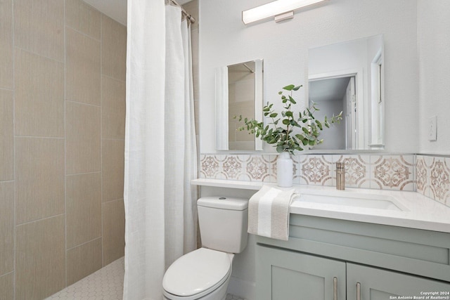 bathroom with curtained shower, vanity, and toilet