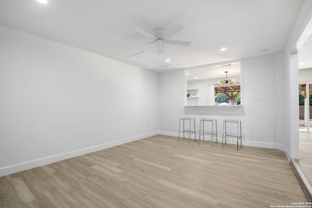 unfurnished living room featuring ceiling fan and light hardwood / wood-style floors