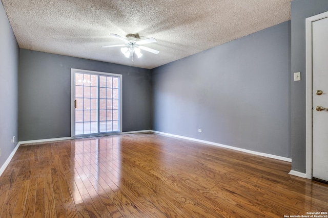 empty room featuring ceiling fan, wood-type flooring, and a textured ceiling