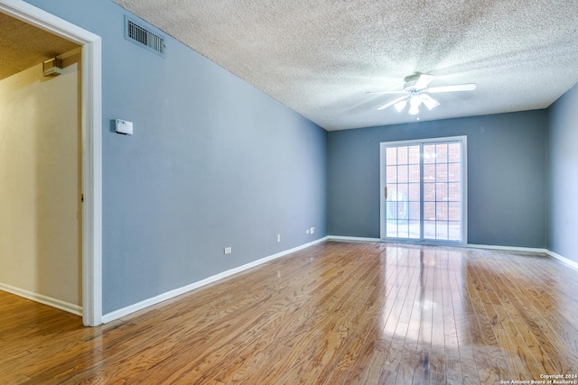 unfurnished room featuring a textured ceiling, ceiling fan, and light hardwood / wood-style flooring