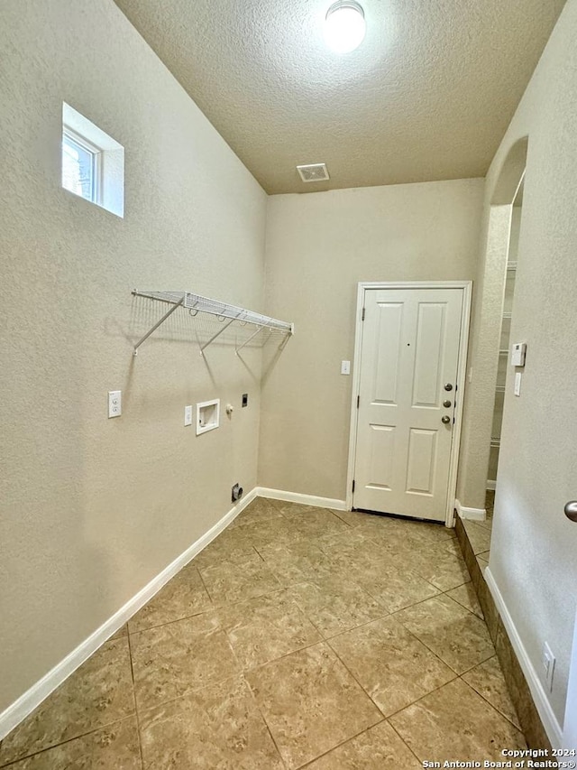 laundry room featuring electric dryer hookup, a textured ceiling, and hookup for a washing machine