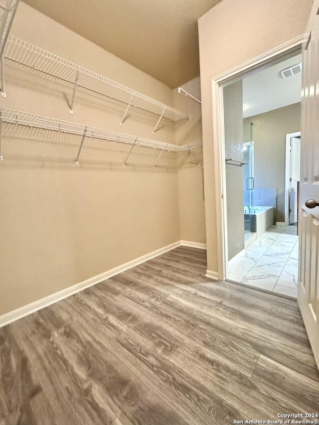 walk in closet featuring hardwood / wood-style floors