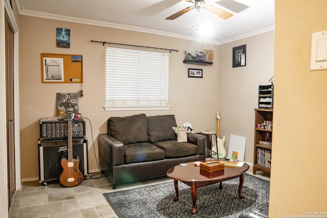 living room featuring crown molding, ceiling fan, and a textured ceiling