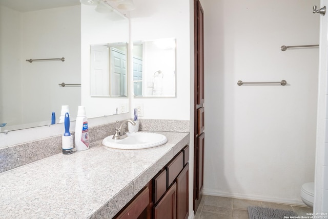 bathroom featuring tile patterned floors, vanity, and toilet