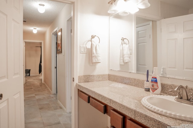 bathroom with vanity and a textured ceiling