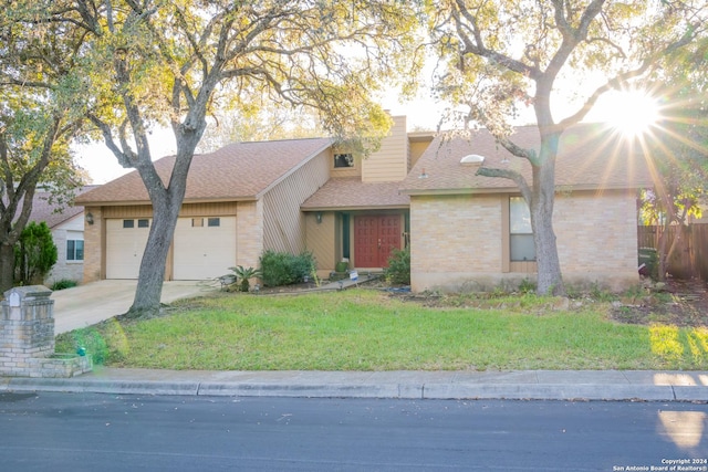 view of front of property with a garage and a front lawn