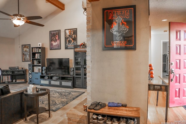 living room featuring hardwood / wood-style floors, lofted ceiling with beams, a textured ceiling, and ceiling fan