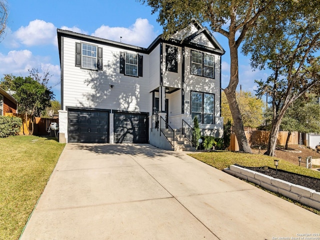 view of front facade featuring a front lawn and a garage