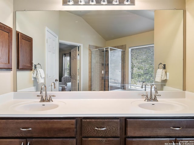 bathroom featuring vanity, an enclosed shower, and lofted ceiling