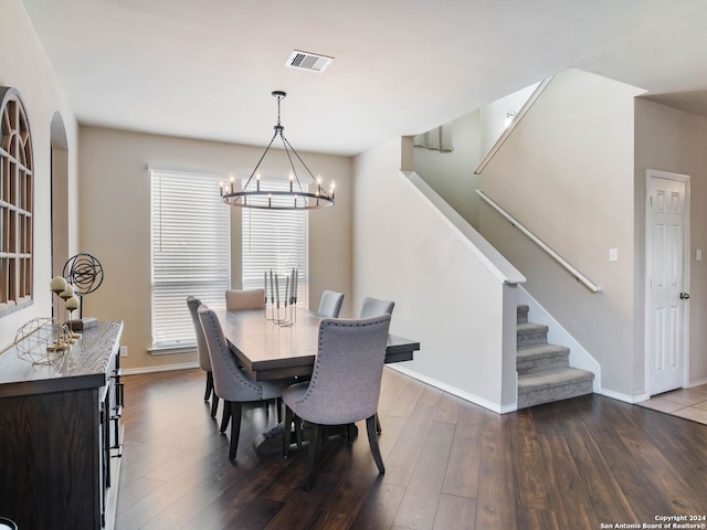 dining area featuring a notable chandelier and dark hardwood / wood-style floors