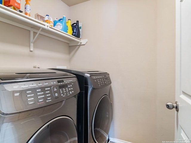 clothes washing area featuring washer and clothes dryer