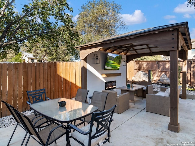 view of patio featuring an outdoor living space with a fireplace