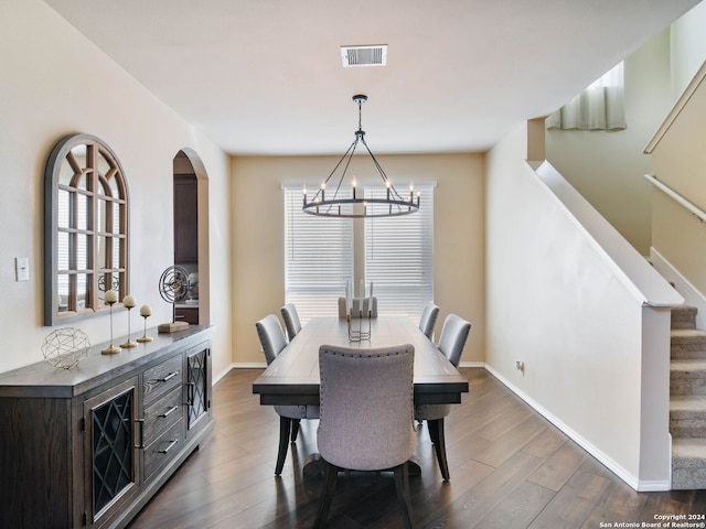 dining room featuring an inviting chandelier and dark wood-type flooring