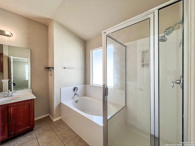 bathroom featuring tile patterned flooring, shower with separate bathtub, vanity, and vaulted ceiling