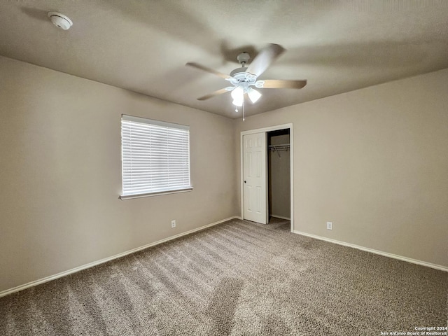 unfurnished bedroom with carpet flooring, ceiling fan, and a closet