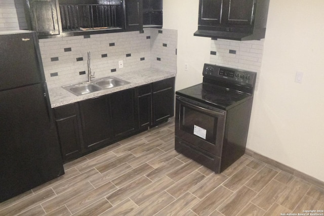 kitchen with sink, backsplash, light stone counters, and black appliances