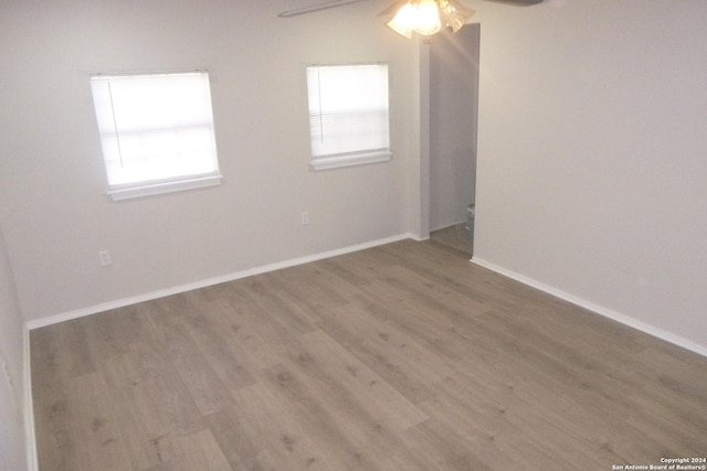 unfurnished room featuring ceiling fan and hardwood / wood-style floors