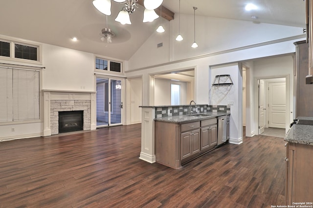 kitchen featuring dark wood-type flooring, high vaulted ceiling, and dark stone counters