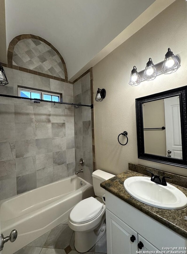 full bathroom featuring toilet, tile patterned flooring, vanity, and tiled shower / bath