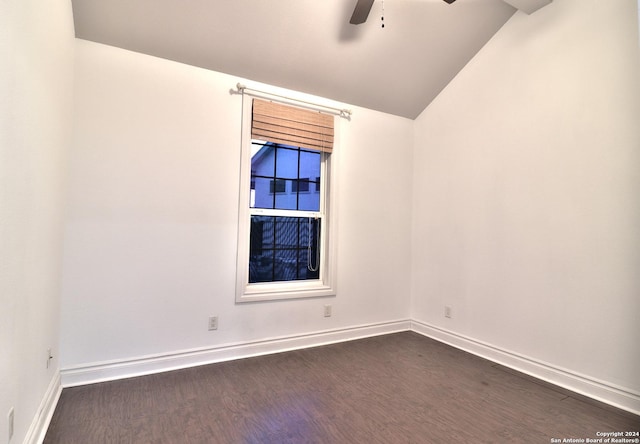 spare room featuring dark hardwood / wood-style floors, ceiling fan, and lofted ceiling