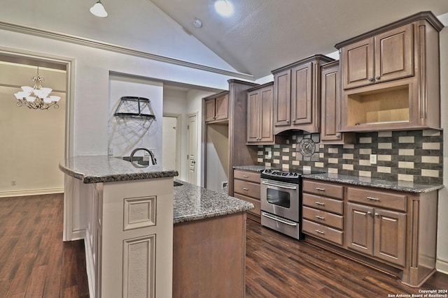 kitchen featuring dark stone counters, vaulted ceiling, an inviting chandelier, stainless steel stove, and dark hardwood / wood-style floors