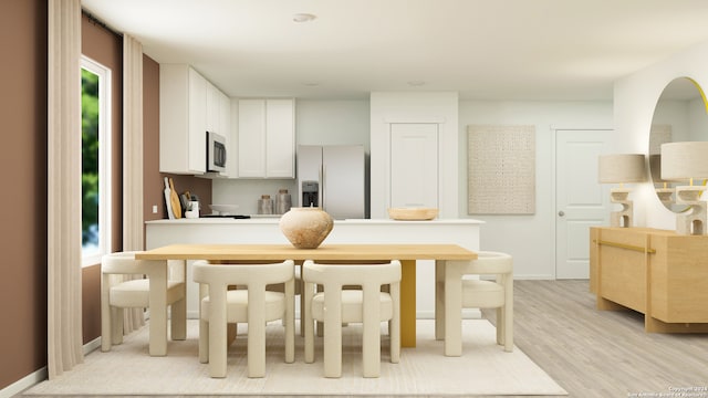 kitchen featuring white cabinets, light wood-type flooring, and white fridge with ice dispenser