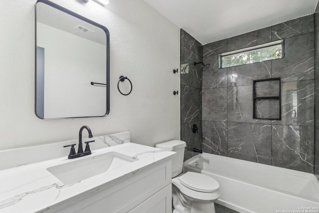 full bathroom with toilet, vanity, and tiled shower / bath combo