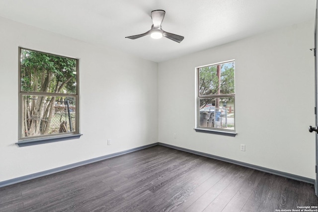 unfurnished room featuring ceiling fan and dark wood-type flooring