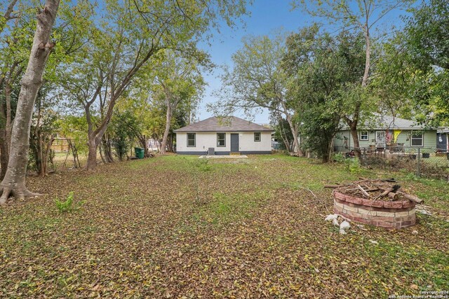 view of yard with an outdoor fire pit