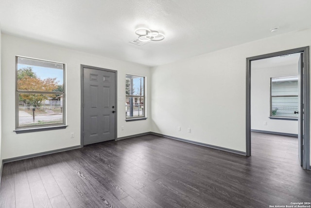 entryway featuring a textured ceiling and dark hardwood / wood-style flooring