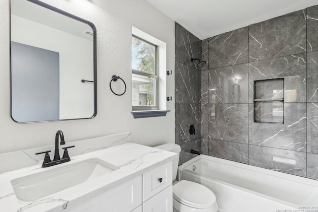 full bathroom featuring vanity, toilet, and tiled shower / bath