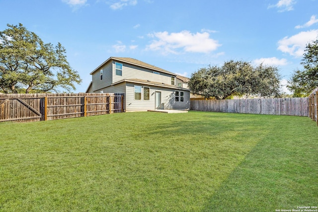 rear view of property featuring a lawn