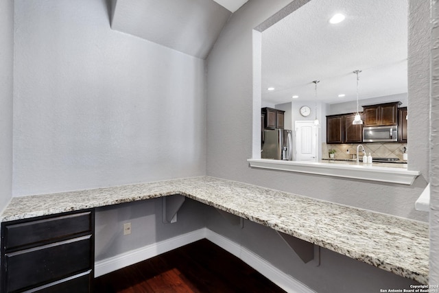 interior space featuring a textured ceiling, built in desk, and dark hardwood / wood-style floors