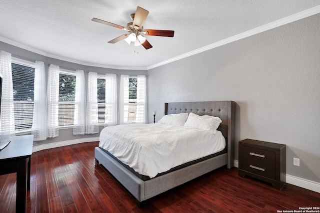 bedroom featuring ceiling fan, crown molding, dark wood-type flooring, and a textured ceiling