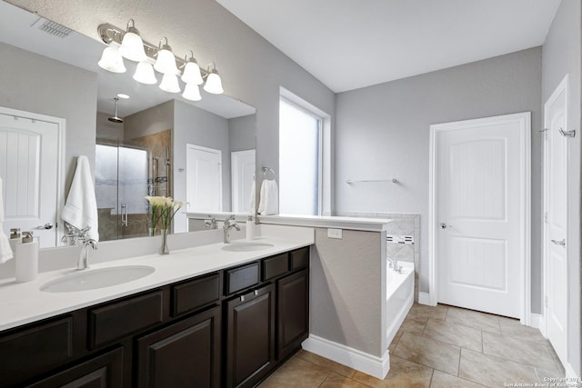 bathroom with tile patterned floors, vanity, and separate shower and tub