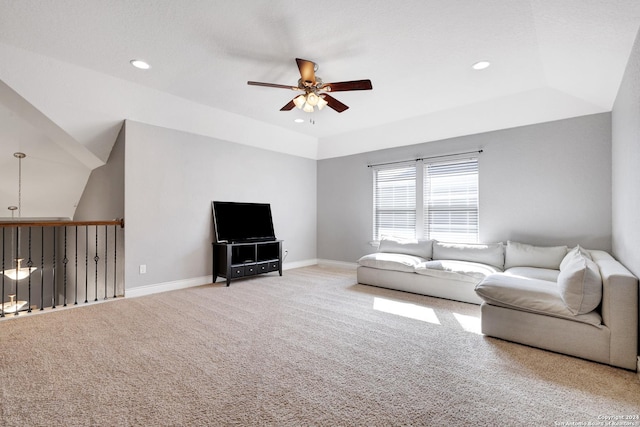 unfurnished living room with ceiling fan, carpet, and vaulted ceiling