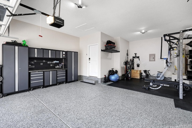 garage with electric panel and a garage door opener