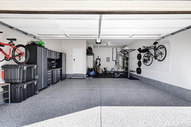 garage with gas water heater and a garage door opener