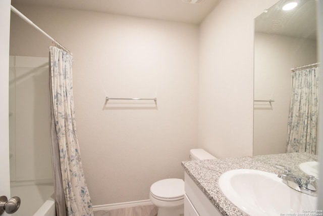 full bathroom featuring vanity, toilet, wood-type flooring, and shower / tub combo