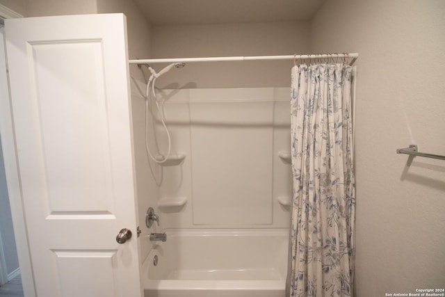 bathroom with shower / bath combo with shower curtain