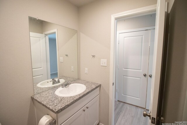 bathroom with hardwood / wood-style floors and vanity