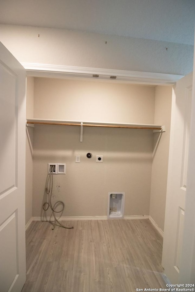 laundry area featuring electric dryer hookup, hookup for a gas dryer, hookup for a washing machine, and hardwood / wood-style flooring