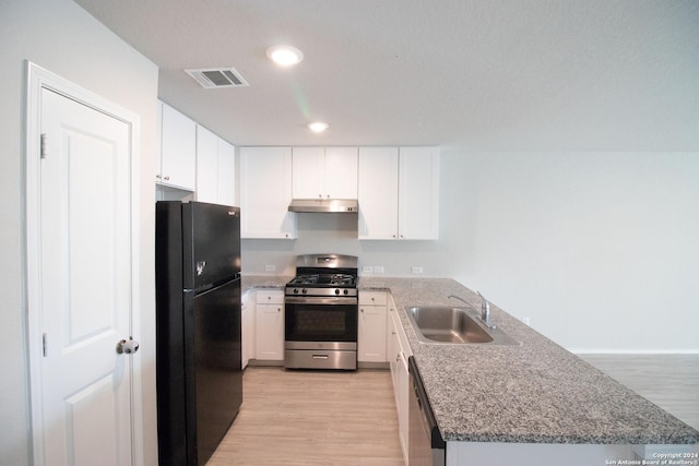 kitchen featuring white cabinets, light wood-type flooring, sink, and appliances with stainless steel finishes