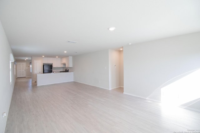 unfurnished living room with light wood-type flooring