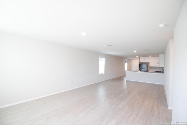 unfurnished living room with light hardwood / wood-style flooring